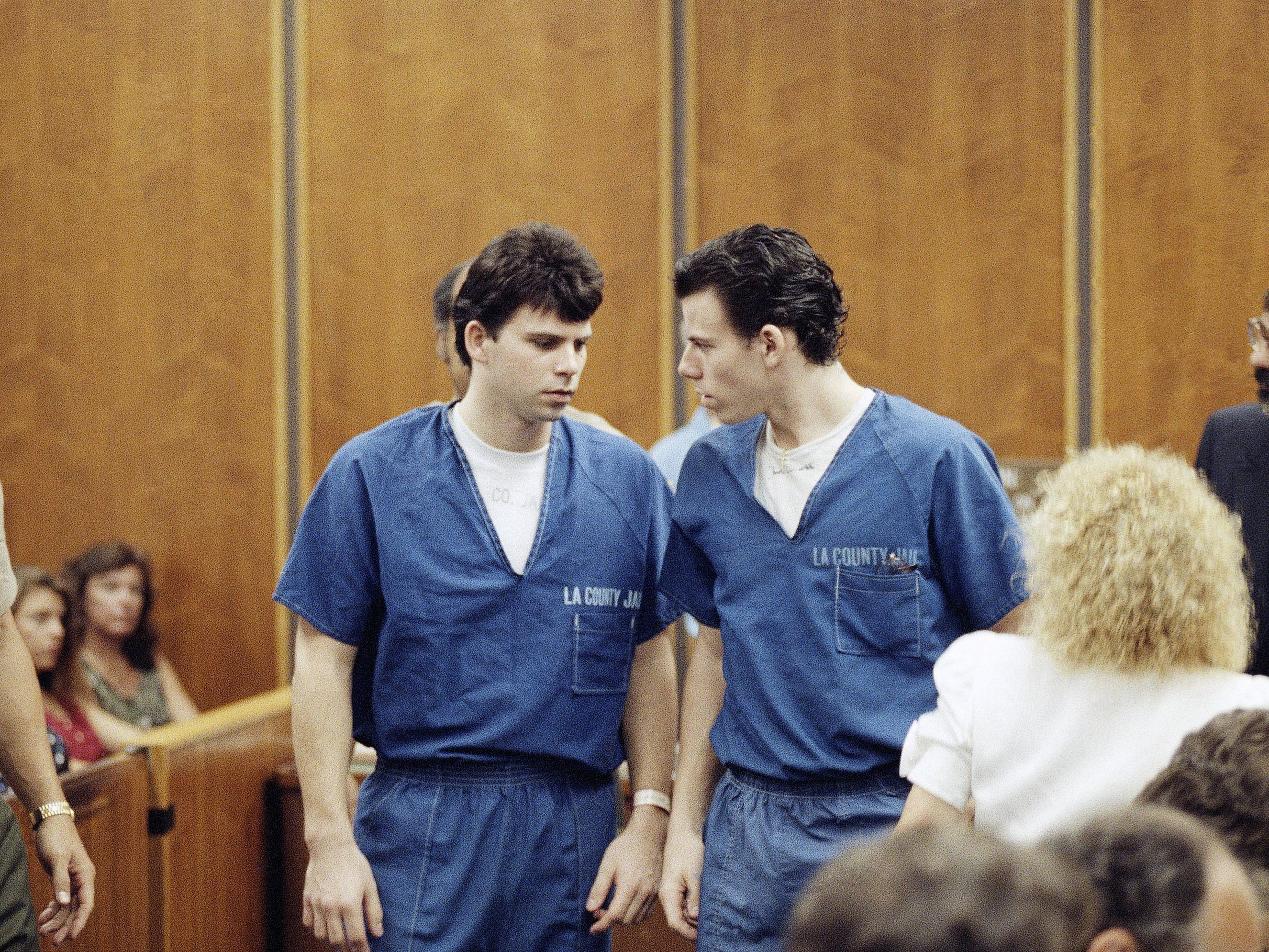 caption: Lyle, left, and Erik Menendez leave the courtroom in Santa Monica, Calif., in August 1990. They were sentenced to life in prison without the possibility of parole in 1996 — and resentenced this week.