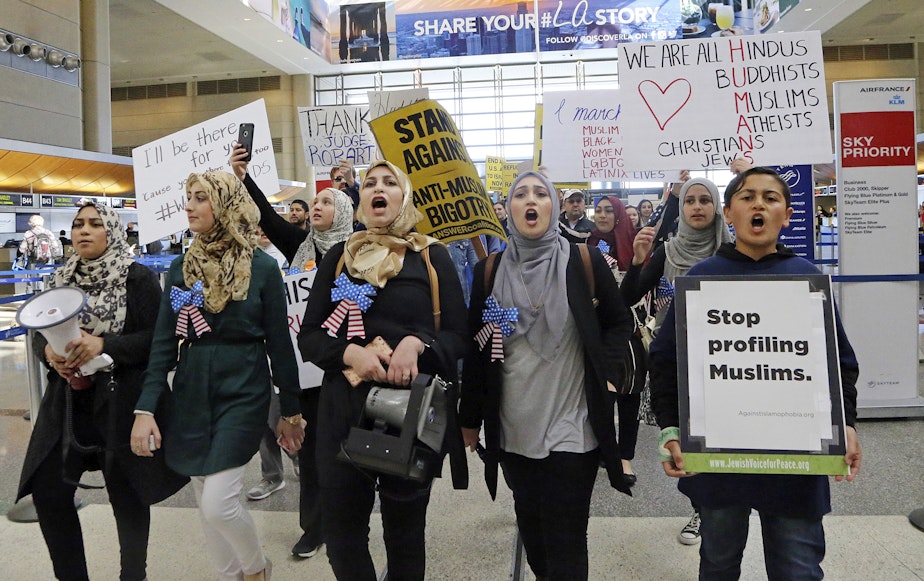 caption: Demonstrators opposed to President Trump's order barring travelers and immigrants from seven predominantly Muslim countries from entering the U.S. march through Los Angeles International Airport Saturday, Feb. 4, 2017.