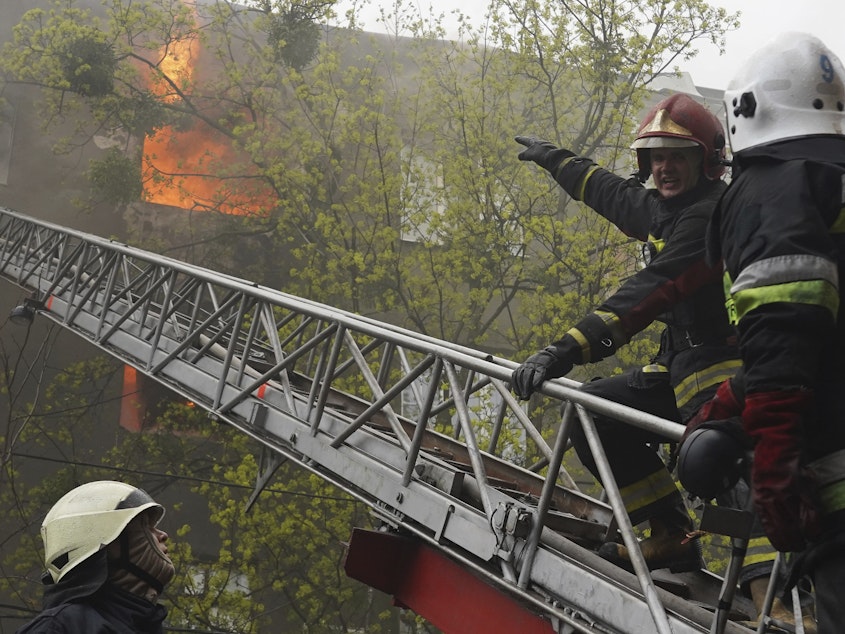 caption: Firefighters work to extinguish fire at an apartment building after a Russian attack in Kharkiv, Ukraine, Sunday, April 17, 2022.