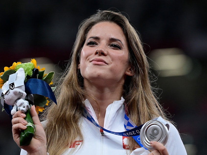 caption: Poland's Maria Magdalena Andrejczyk celebrates her silver medal in the javelin throw at the Olympic Stadium in Tokyo on Aug. 7. She auctioned the medal to help fund heart surgery for an 8-month-old.
