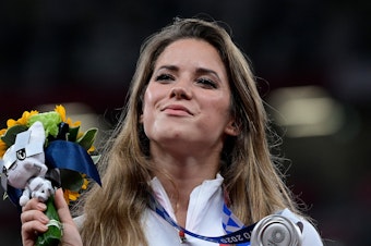 caption: Poland's Maria Magdalena Andrejczyk celebrates her silver medal in the javelin throw at the Olympic Stadium in Tokyo on Aug. 7. She auctioned the medal to help fund heart surgery for an 8-month-old.