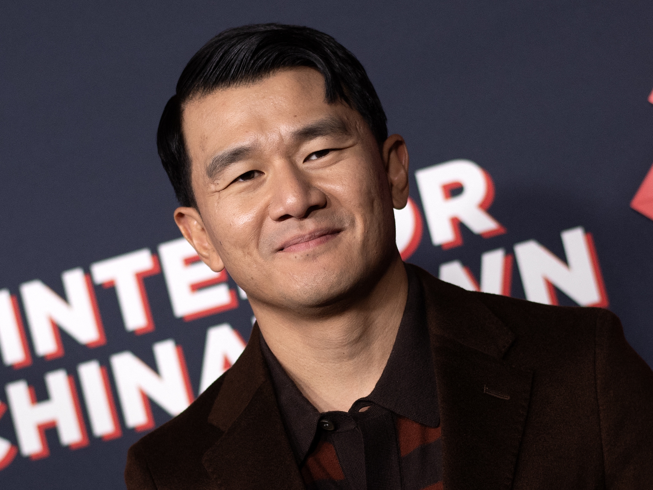 caption: Ronny Chieng arrives for the premiere of Hulu's <em>Interior Chinatown</em> at the Linwood Dunn Theater in Los Angeles on Nov. 13, 2024.