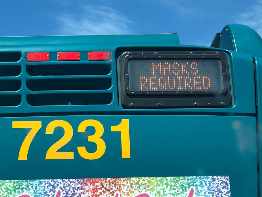 caption: A King County Metro bus in Seattle, Aug. 2, 2020, with a message that masks are required on the bus.