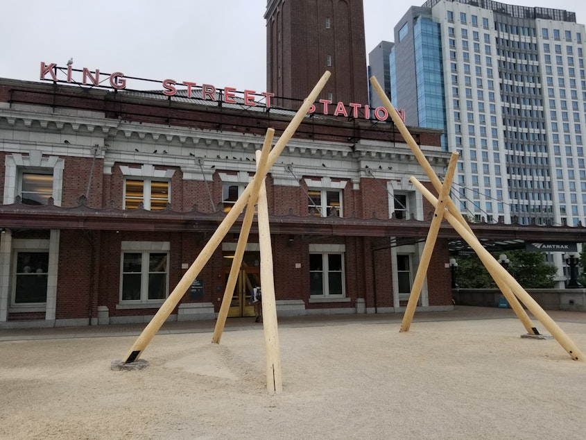 caption: "Brings the Medicine Sundial" by Kimberly Corinne Deriana with Salish carvers is installed outside Seattle's King Street Station