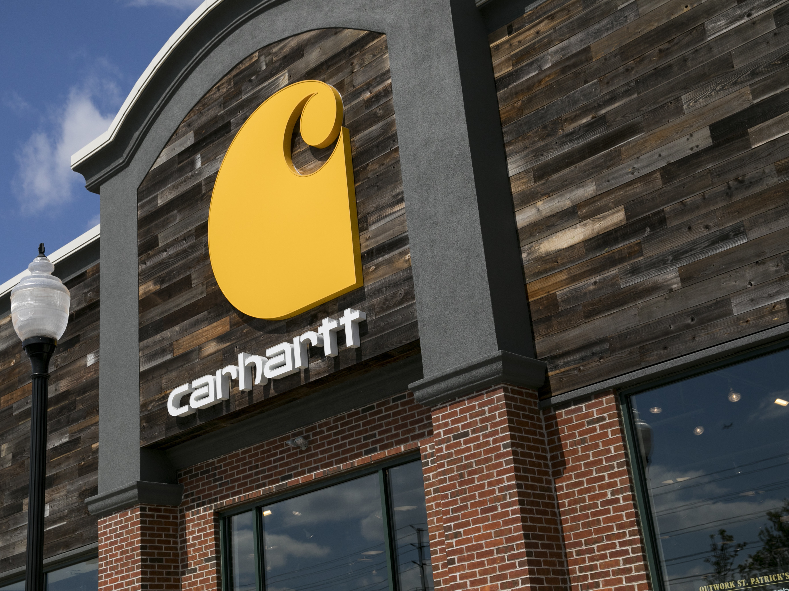 caption: A logo sign outside of a Carhartt retail store location in Cherry Hill, New Jersey on April 11, 2020. The company is facing blowback among some conservatives for its decision to press ahead with a vaccine mandate for its employees.