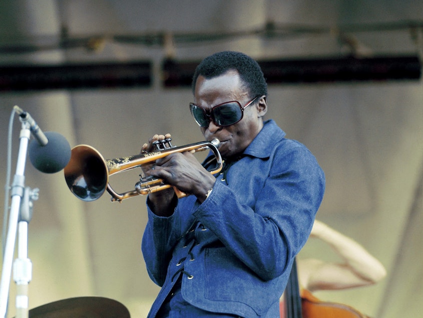 caption: Miles Davis performing at Newport Jazz Festival in 1969.