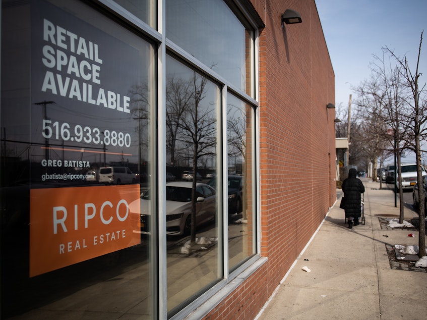 caption: A "Retail Space Available" sign is displayed in the window of a closed JPMorgan Chase & Co. branch in the Bronx borough of New York, on Feb. 22, 2019. Banks have been closing branches, a trend that has accelerated during the pandemic as more people manage their accounts online.