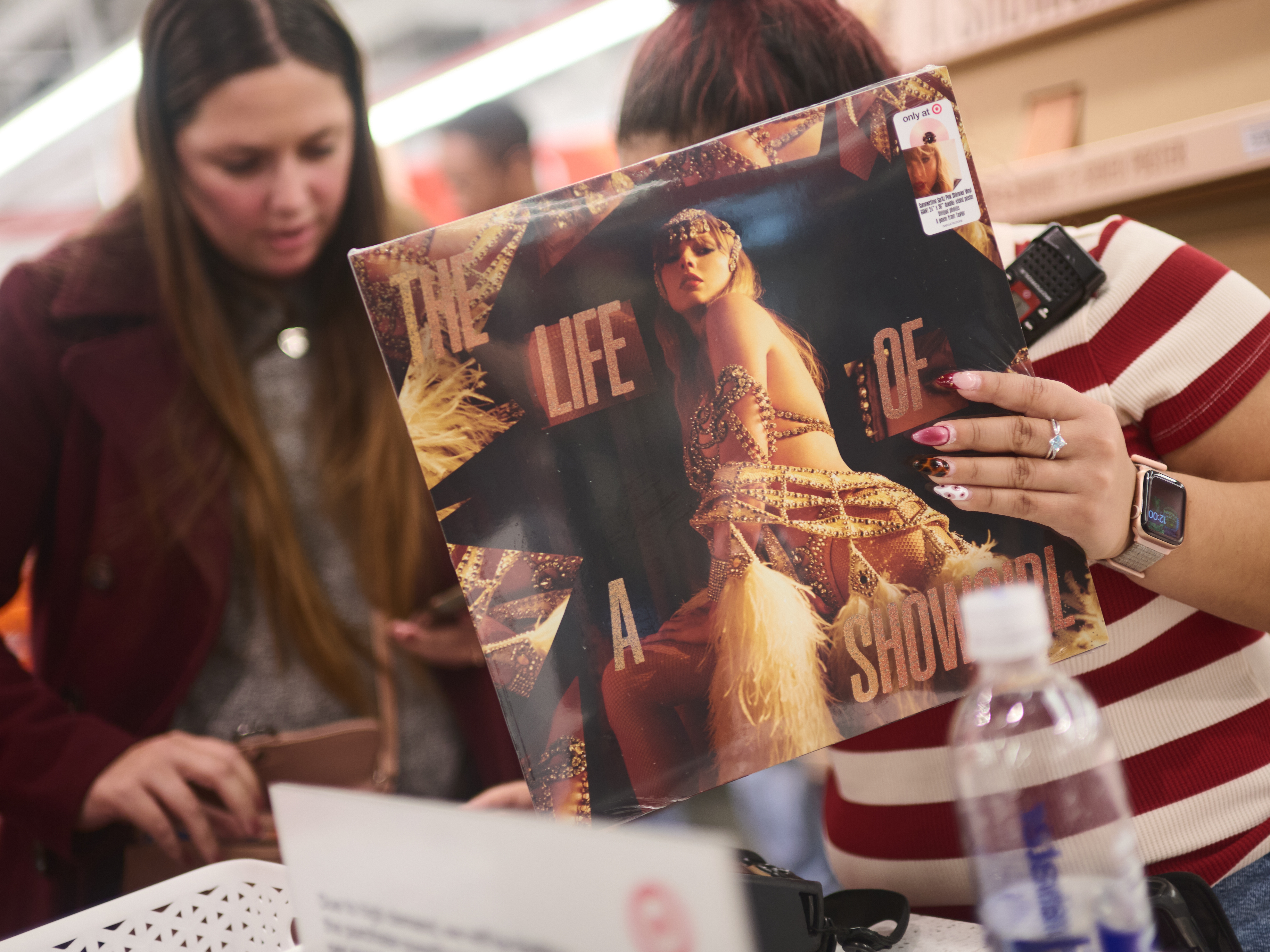 caption: Fans at a New York City Target shop for Taylor Swift's album <em>The Life of a Showgirl</em> on its Oct. 3 release night.