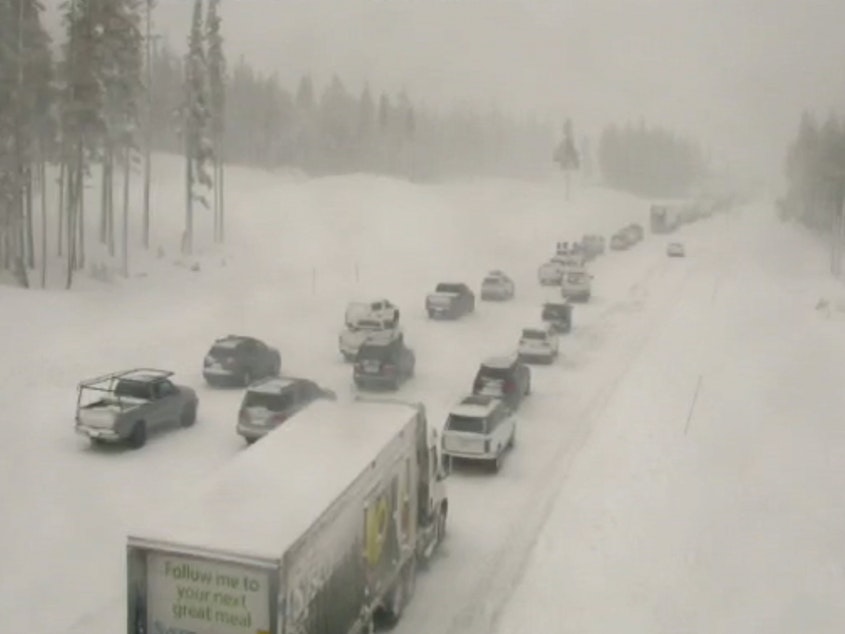 caption: In this image taken from video from a Caltrans remote video traffic camera, traffic is stopped along a snow covered Interstate 80 at Donner Summit, Calif., on Thursday. Snow continued over the Christmas weekend in the area.