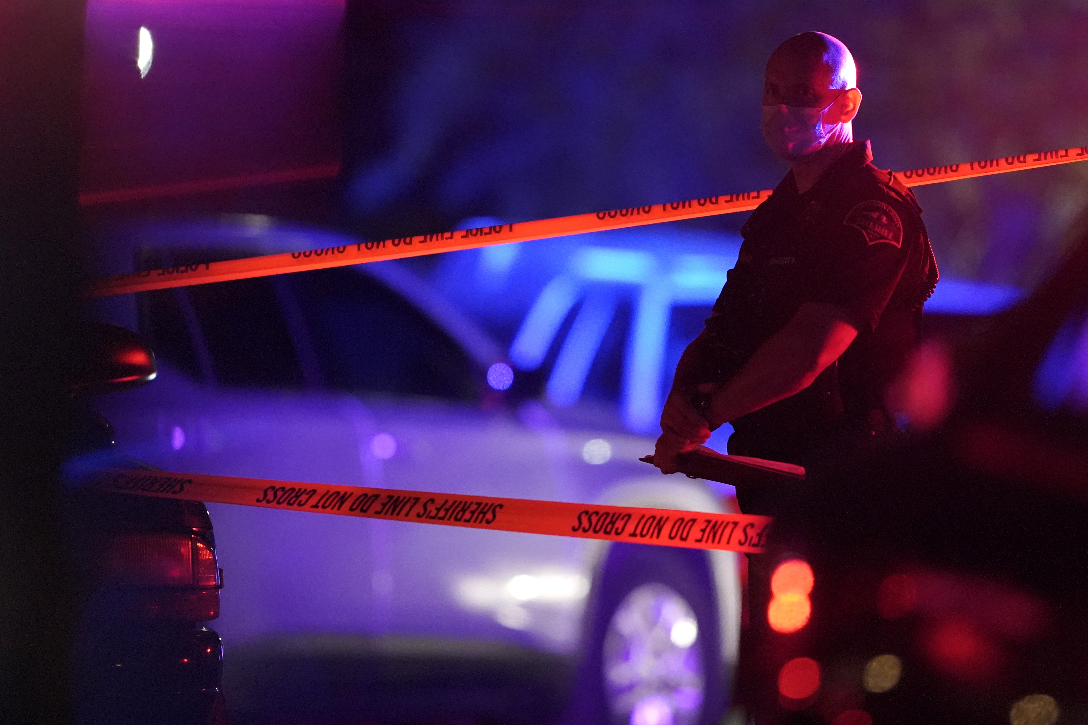 caption: A Thurston County Sheriff's Deputy wears a mask as he stands near crime scene tape, Thursday, Sept. 3, 2020, in Lacey, Wash. at the scene where Michael Reinoehl was killed Thursday night as investigators moved in to arrest him. Reinoehl had been suspected of fatally shooting a supporter of a right-wing group in Portland, Oregon, last week after a caravan of Donald Trump backers rode through downtown Portland. 


