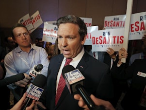 caption: Ron DeSantis, seen speaking to reporters from Fox News in 2018 when he was running for governor of Florida, has been prominent in a recent trend of Republicans ignoring or actively avoiding mainstream press, particularly national outlets.