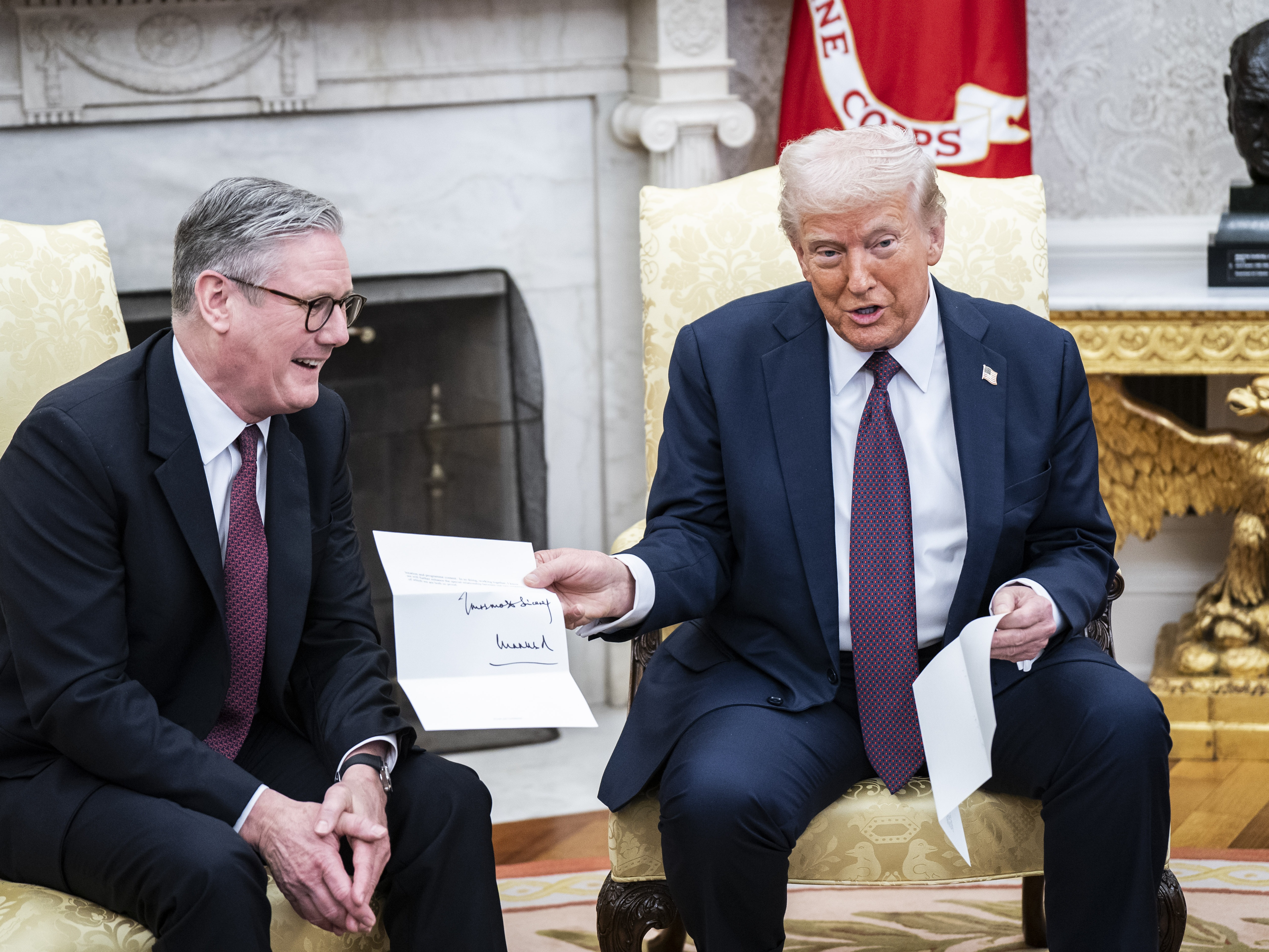 caption: President Trump is given a letter from King Charles III, by British Prime Minister Keir Starmer in the Oval Office at the White House on Feb 27.
