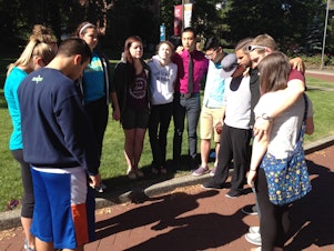 caption: Seattle Pacific University students gather in the "Tiffany Loop" on campus Friday to pray for each other in the wake of the shooting Thursday.