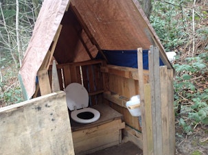 caption: A latrine in the homeless encampment known as the Jungle. 