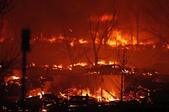 caption: Dec. 30: Broomfield, Co. — Homes burn as a wildfire rips through a development near Rock Creek Village.