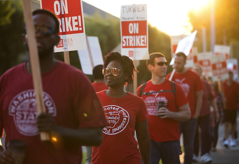 caption: Katrice Cyphers, second from left, marches with teachers on strike outside of Foster High School on Tuesday, September 5, 2018, in Tukwila.