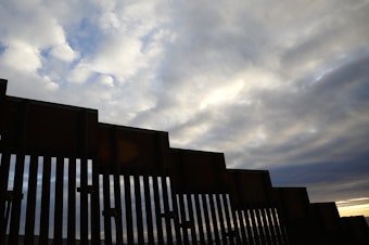 caption: A section of border wall separates Tijuana, Mexico, from San Diego, as seen from the U.S. in January. California has filed a lawsuit along with 15 other states, calling President Trump's use of a national emergency declaration to redirect money toward border wall construction unconstitutional.
