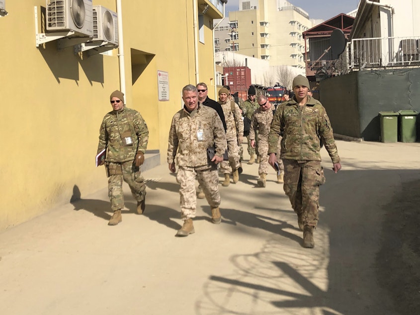 caption: Marine Gen. Frank McKenzie (center) visits Kabul, Afghanistan, in January 2020. The Biden administration said it plans to complete a drawdown of U.S. troops in the country by Sept. 11.