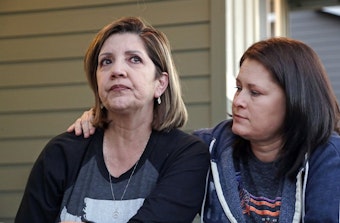 caption: Survivors of the Oct. 1, 2017, Las Vegas shooting are still struggling to put their lives back together one year later. Chris Gilman, right, of Bonney Lake, Wash., says she still has the urge to look behind her whenever she leaves her home. Her wife, Aliza Correa, and two off-duty sheriff’s deputies helped save her. CREDIT: AP PHOTO/ELAINE THOMPSON