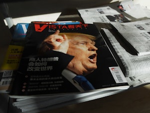 caption: A magazine's cover line in Beijing asks, "How will Trump the businessman change the world?" on Dec. 28, 2016, days after then President-elect Donald Trump tapped outspoken China critic Peter Navarro for a top trade position.