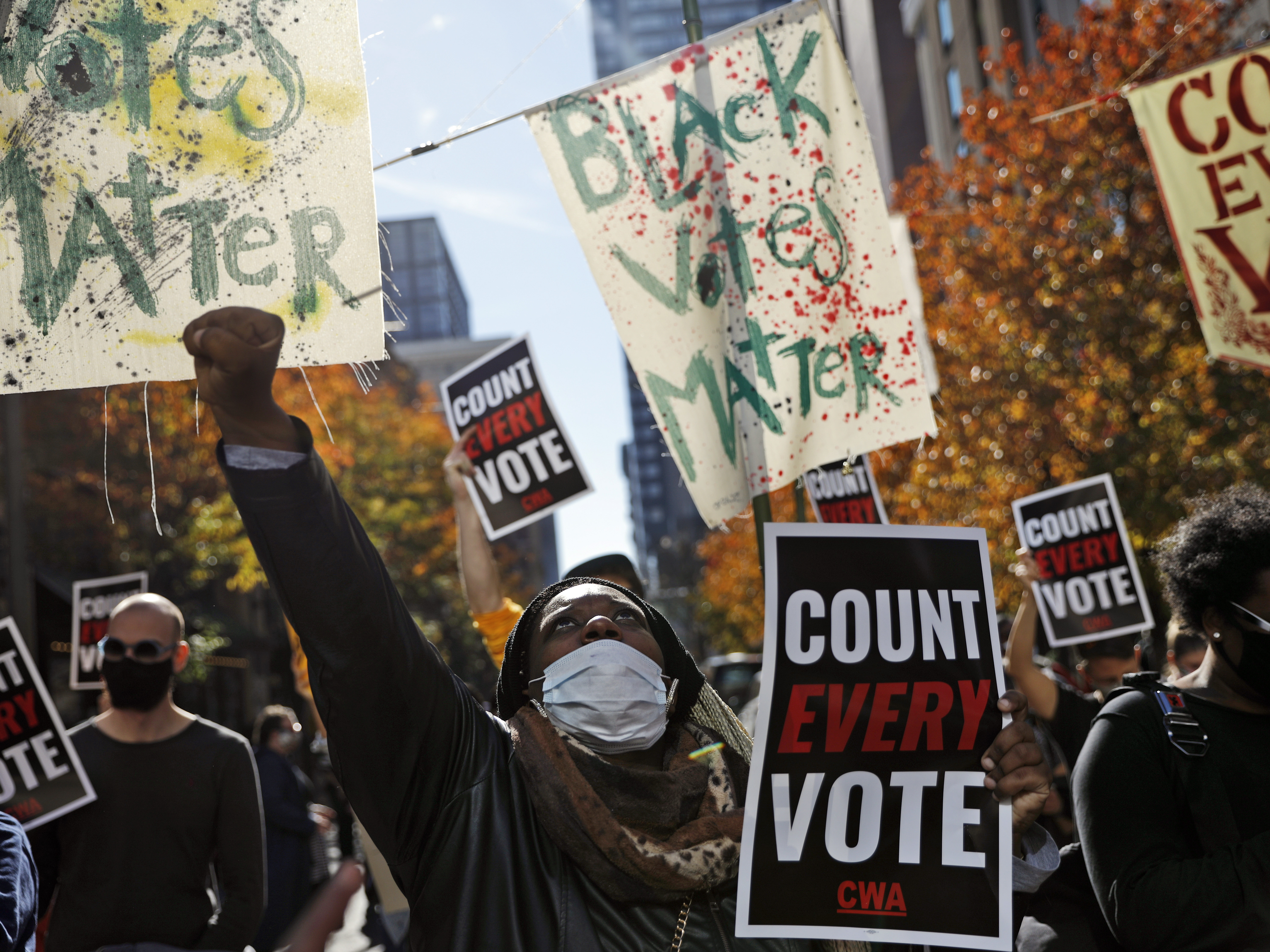caption: Zhanon Morales, 30, of Philadelphia raises a fist during a Nov. 5 voting rights rally. President Trump's campaign unsuccessfully used spurious claims of voter fraud to invalidate votes in Philadelphia and other largely Black cities.
