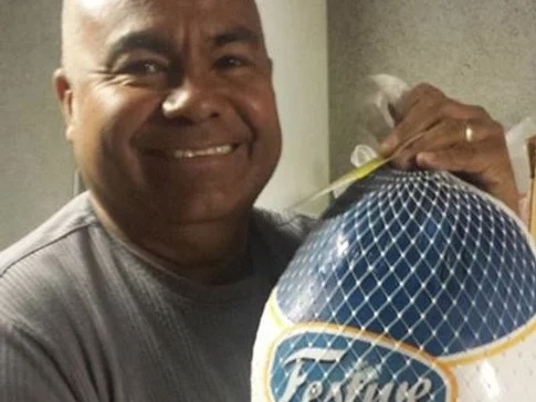 caption: Jose Manuel Castro, the pastor of Gethsemani Baptist Church, holds a turkey. The church had a tradition of giving away turkeys every Thanksgiving except this past year due to troubles with the city, according to a suit.