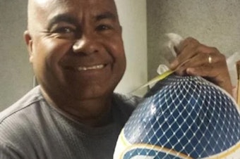 caption: Jose Manuel Castro, the pastor of Gethsemani Baptist Church, holds a turkey. The church had a tradition of giving away turkeys every Thanksgiving except this past year due to troubles with the city, according to a suit.