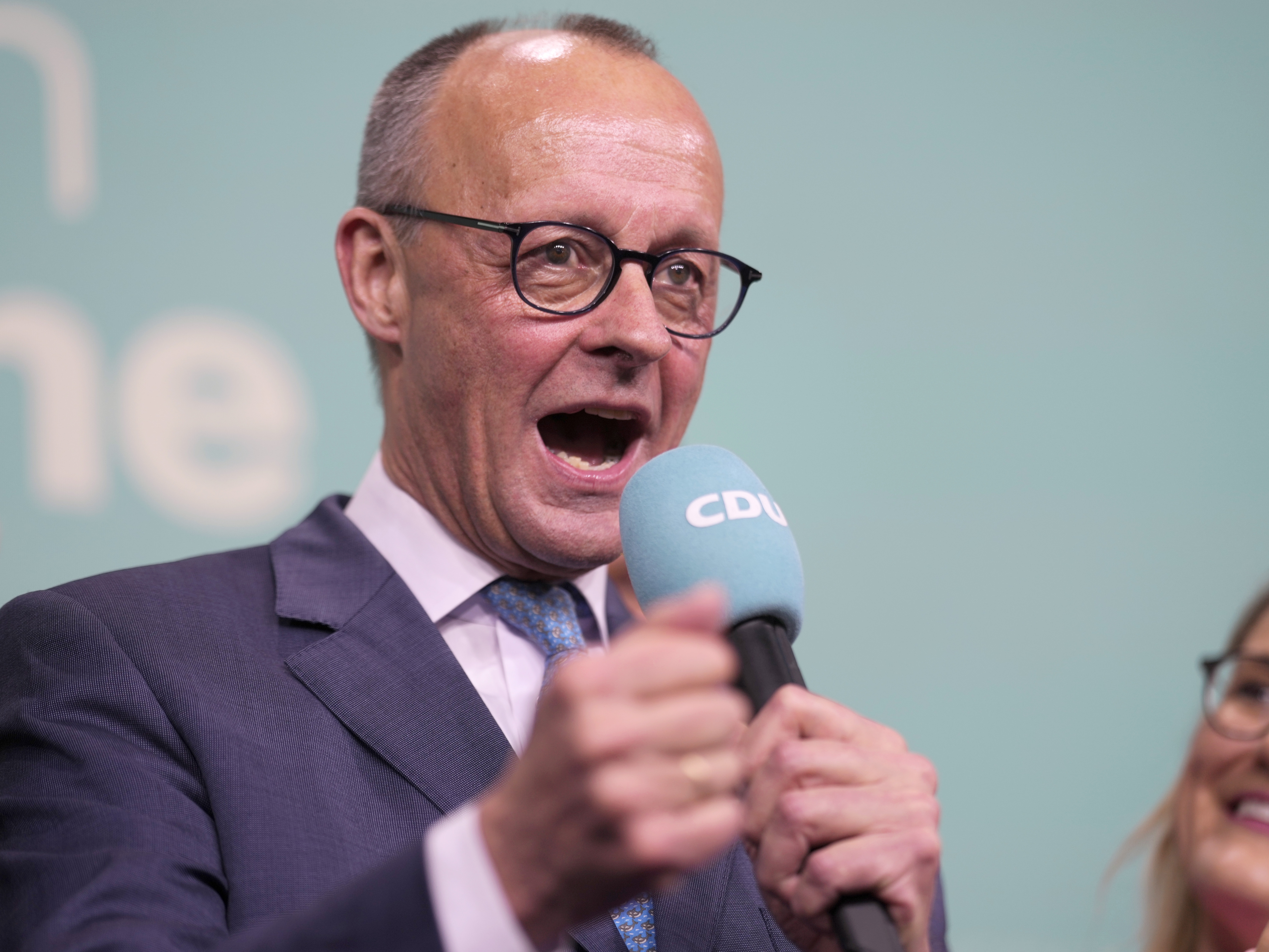 caption: Friedrich Merz, the candidate of the mainstream conservative Christian Democratic Union party, gestures while addressing supporters at the party headquarters in Berlin, Germany, on Sunday.