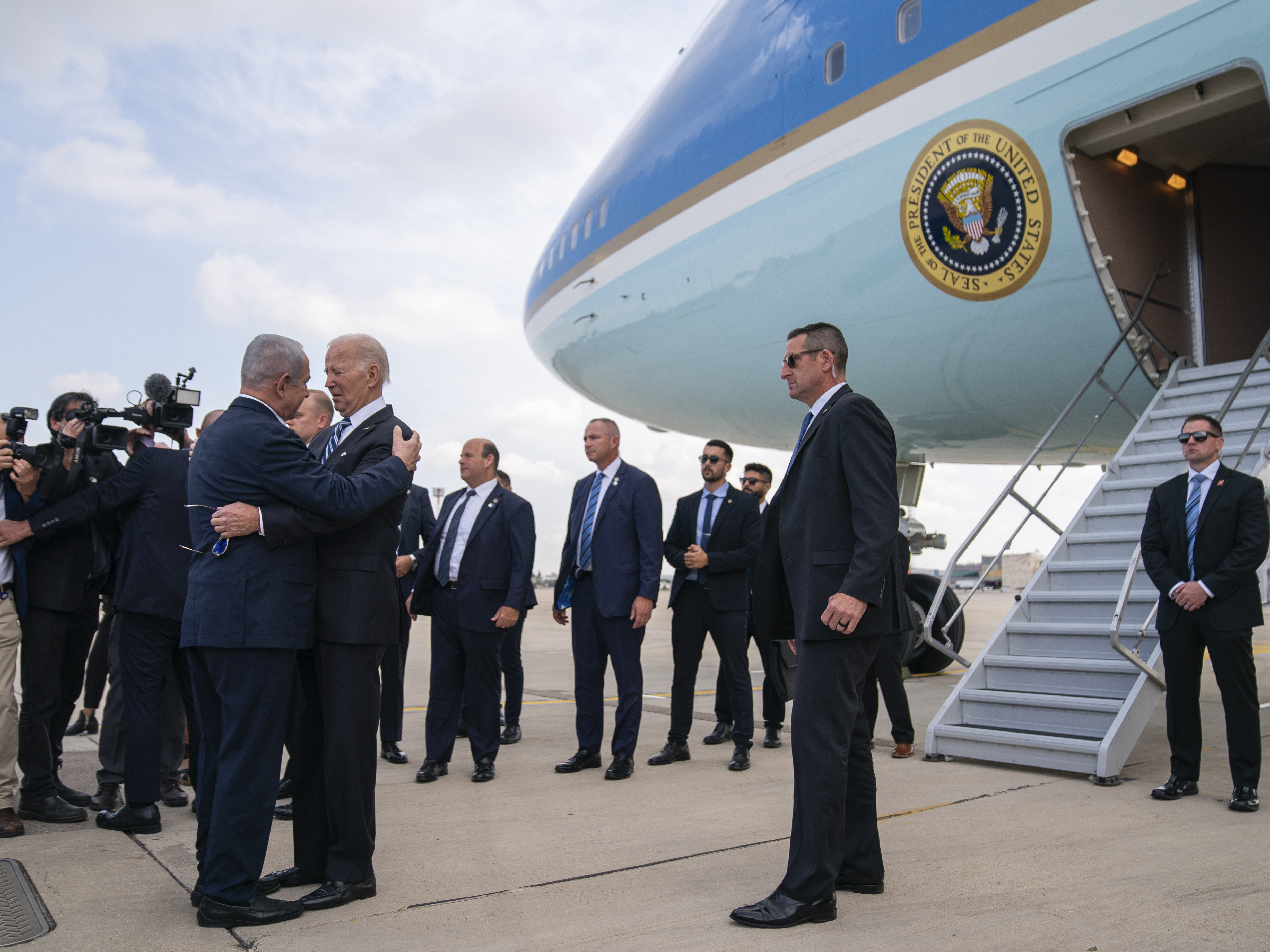 caption: President Biden is greeted by Israeli Prime Minister Benjamin Netanyahu after arriving at Ben Gurion International Airport, Wednesday in Tel Aviv.