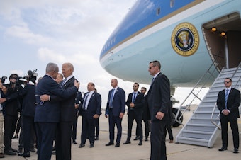 caption: President Biden is greeted by Israeli Prime Minister Benjamin Netanyahu after arriving at Ben Gurion International Airport, Wednesday in Tel Aviv.