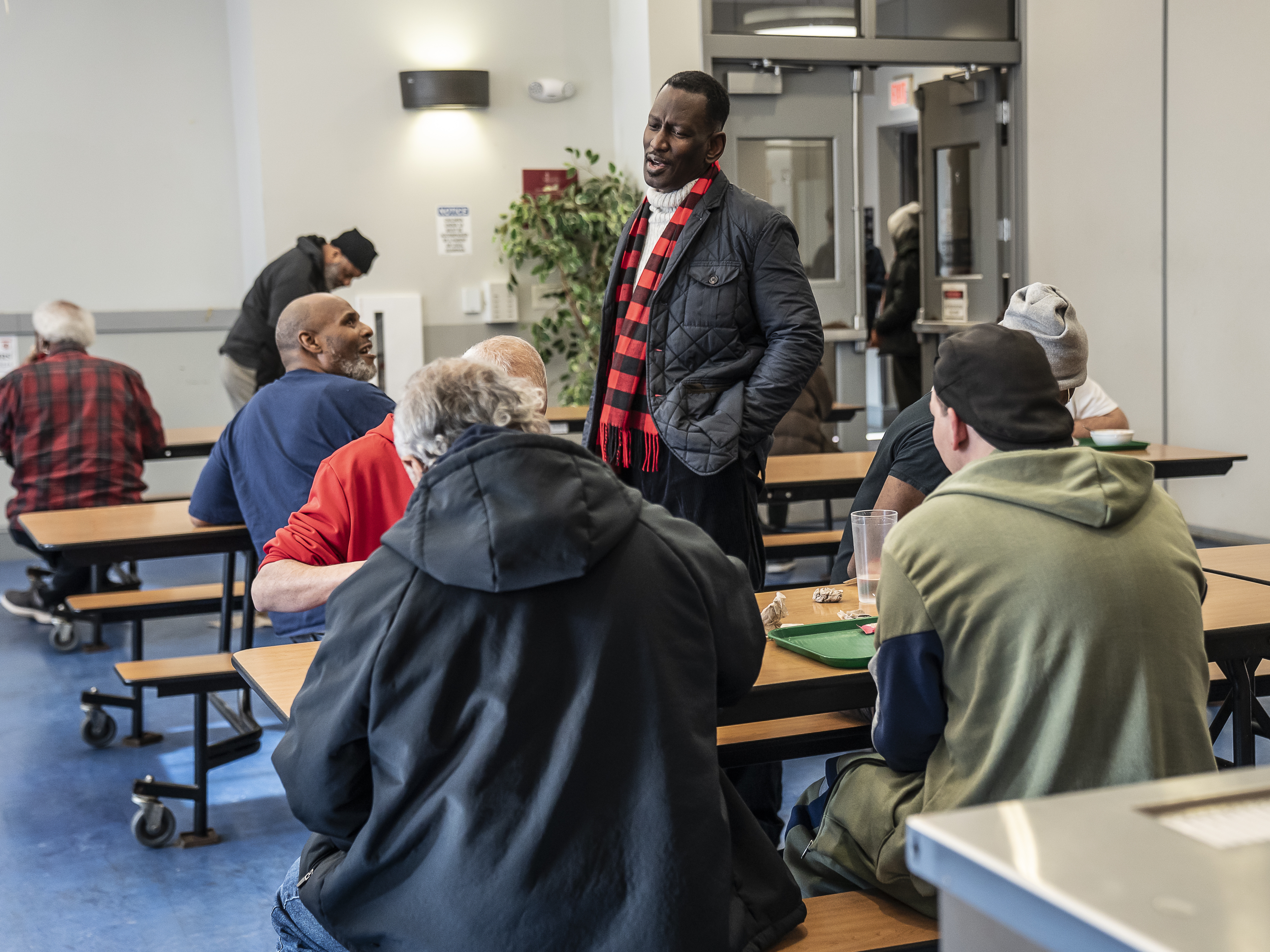 caption: Ron Stanley Jr., a pastor who serves as the vice president of men's ministry, socializes with residents and supporters of Central Union Mission in Washington, D.C.