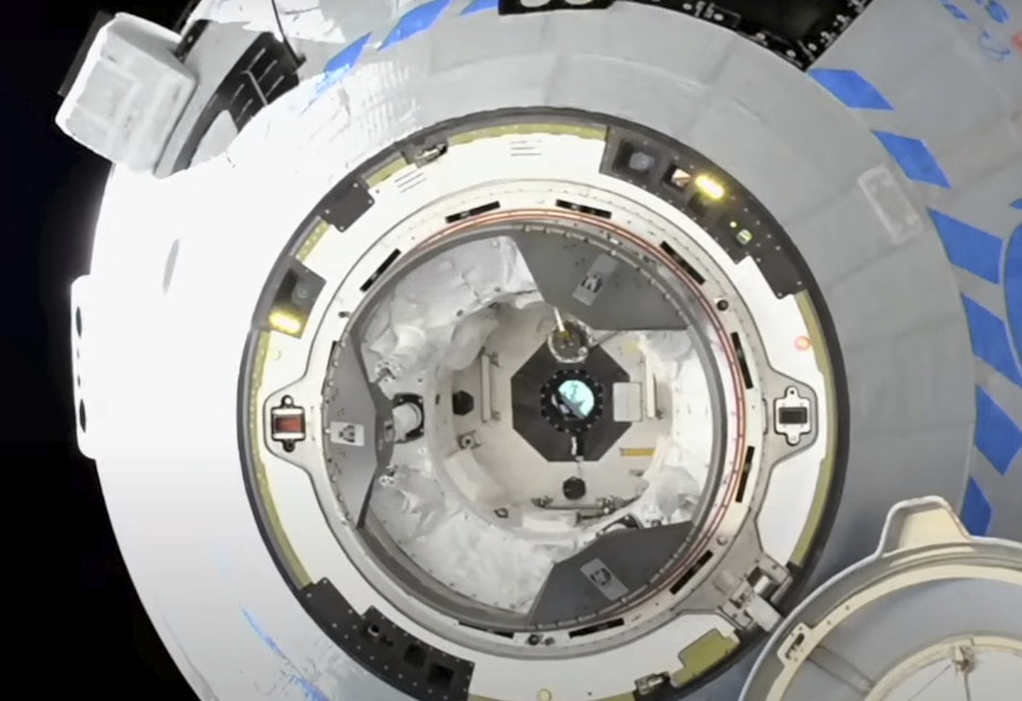 caption: The Boeing Starliner prepares to dock at the International Space Station on Friday.