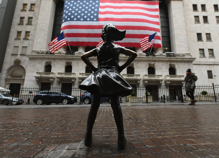 caption: The Fearless Girl statue stands in front of the New York Stock Exchange near Wall Street on March 23, 2020 in New York City. (Angela Weiss/AFP via Getty Images)