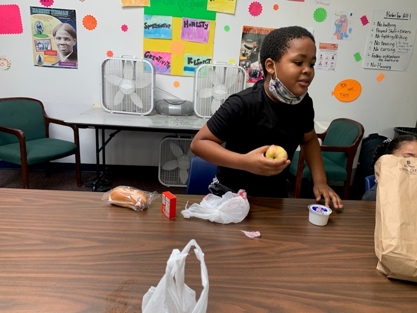 caption: Elijah Baker, 9, a fourth grader at Leschi Elementary attends remote school from the Central Area Youth Association. 