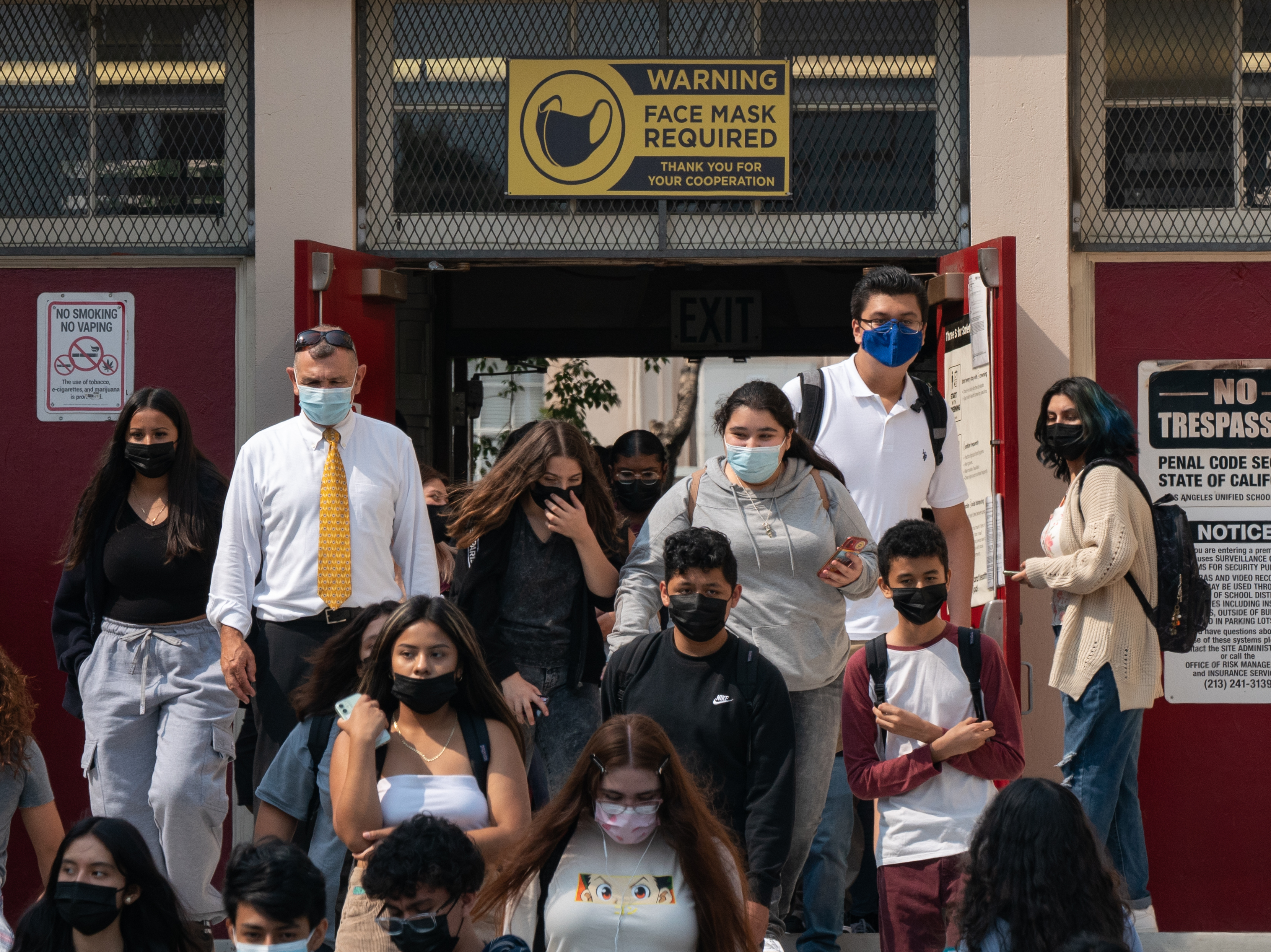 caption: Students and staff exit Hollywood High School after the first day of school in Los Angeles.