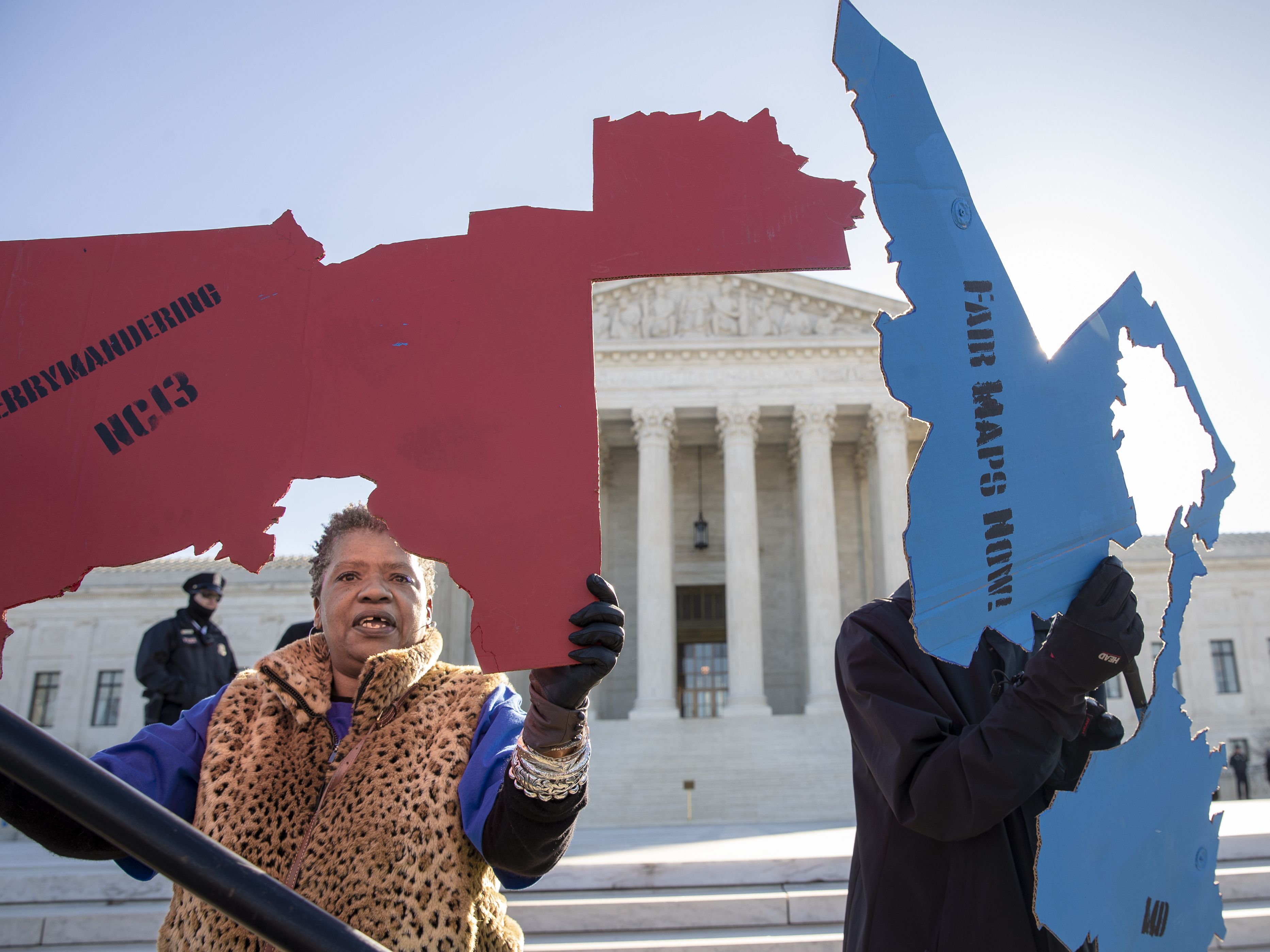 caption: Activists at the Supreme Court opposed to partisan gerrymandering hold up representations of congressional districts from North Carolina (left) and Maryland on March 26. On June 27, justices decided that the practice is beyond the reach of federal courts.