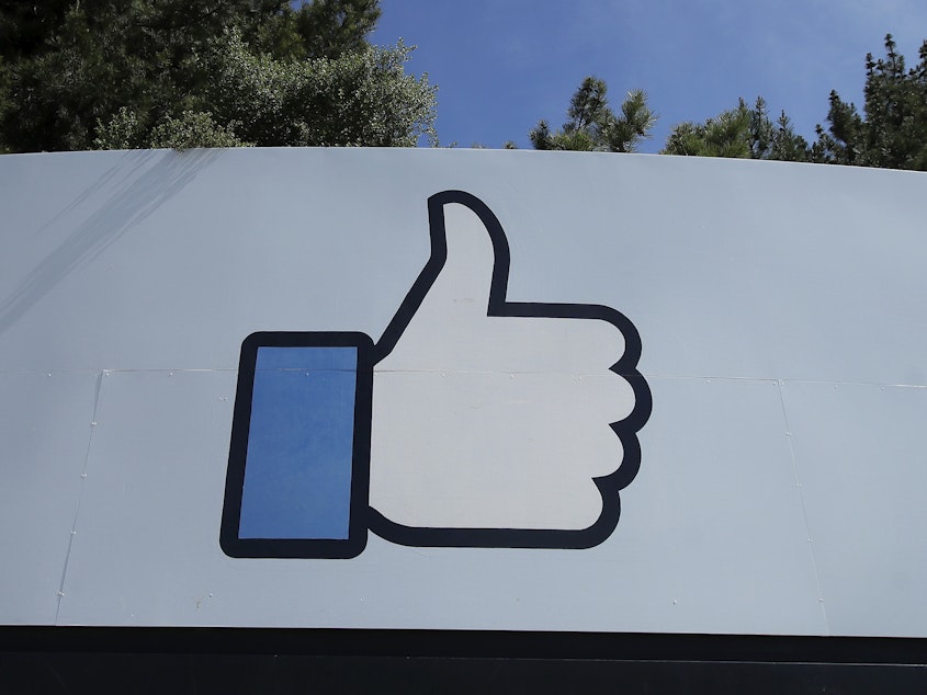 caption: Facebook's thumbs-up "Like" logo is shown on a sign at the company's headquarters in Menlo Park, Calif.