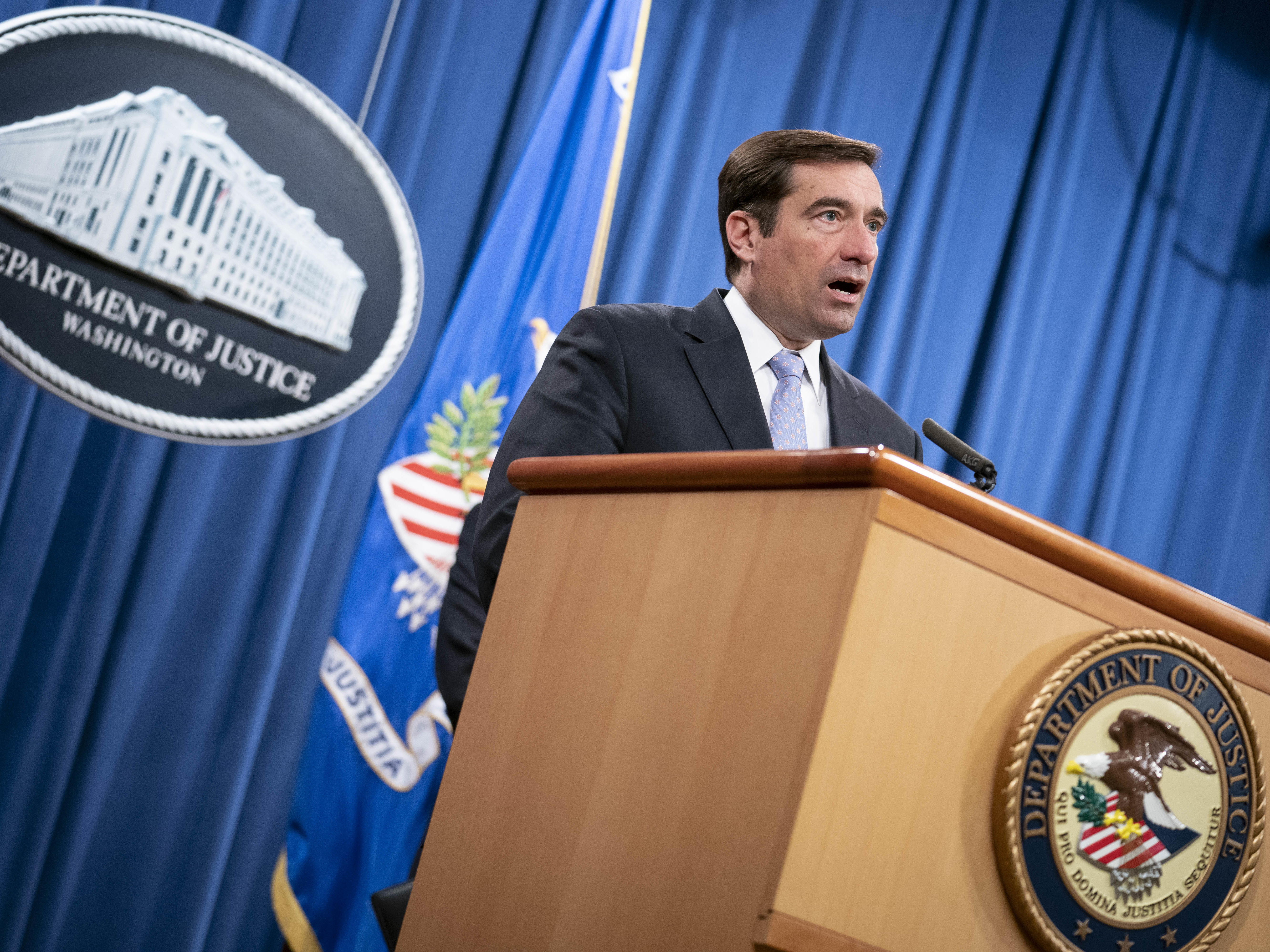 caption: John Demers, pictured in October 2020, announced indictments against three North Korean hackers for a series of worldwide cyberattacks.