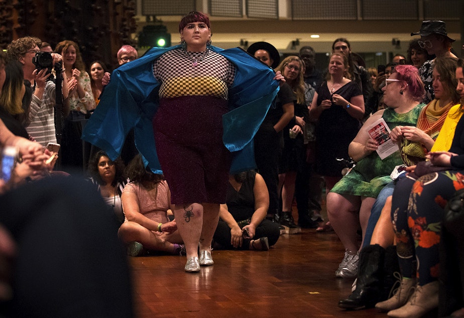 caption: Peyton Oller models on the runway during Big Mood: A Night of Fat Fashion on Wednesday, September 25, 2019, at the Museum of History and Industry in Seattle. 