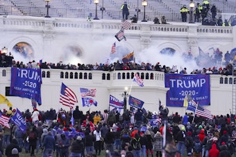 caption: Rioters on the West Front at the U.S. Capitol on Jan. 6, 2021, in Washington. (John Minchillo/AP)