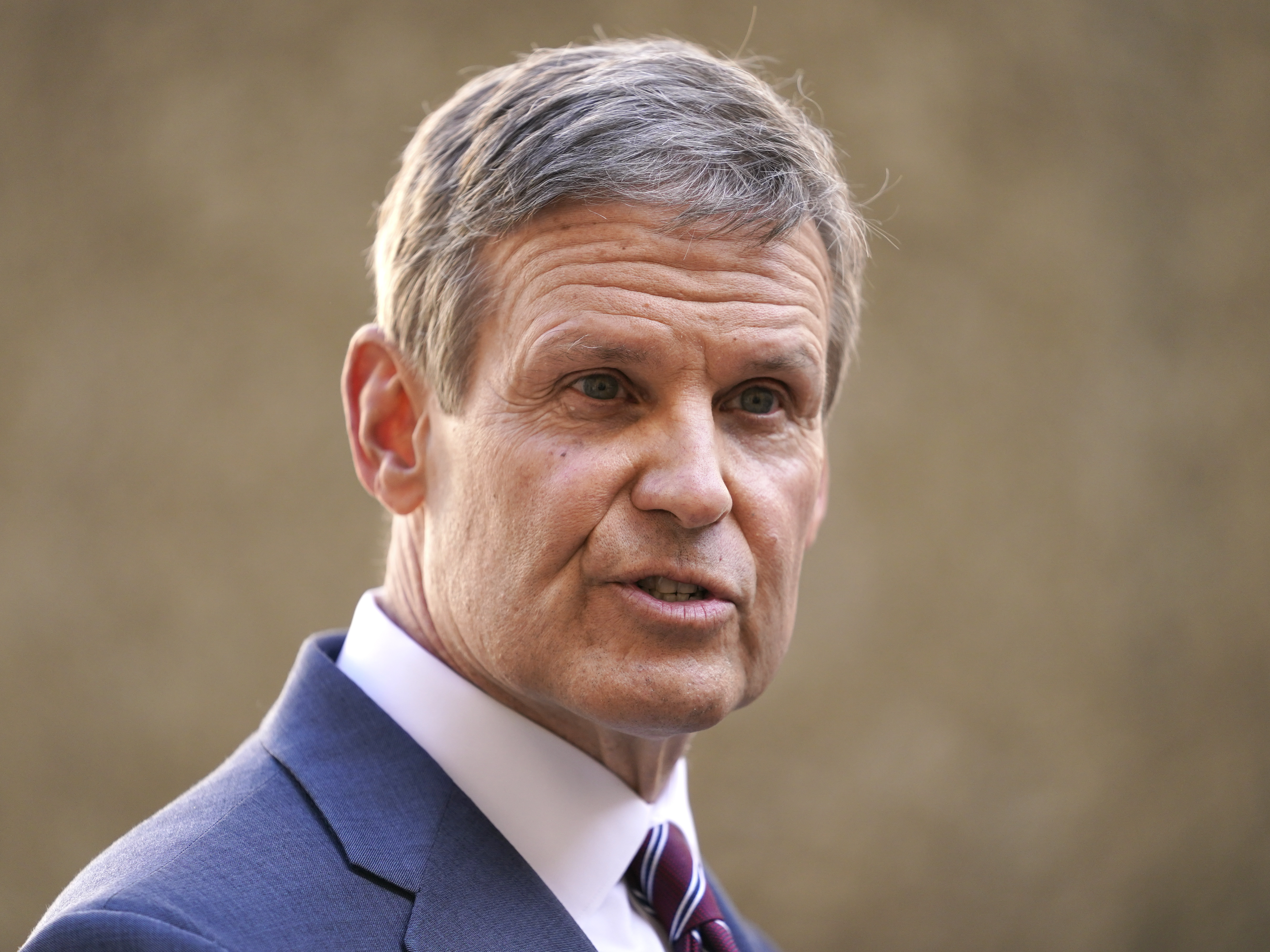 caption: Tennessee Gov. Bill Lee speaks to reporters Tuesday, Jan. 19, 2021, in Nashville, Tenn. He released a video on Wednesday inviting law enforcement officers from across the country to join the Tennessee Highway Patrol.