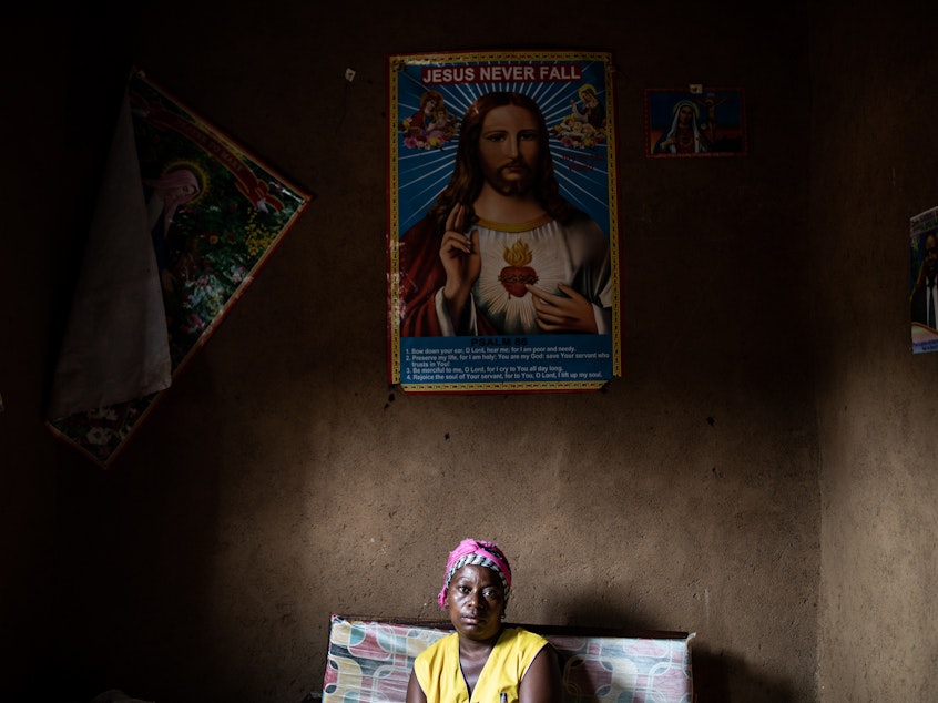caption: Janine Kibwana, Ebola survivor and mother of five, sits in her living room in Beni, Democratic Republic of the Congo. Researchers studying the DRC's most recent Ebola outbreak say that a new vaccine can dramatically reduce the risk of dying from the disease.