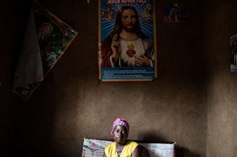 caption: Janine Kibwana, Ebola survivor and mother of five, sits in her living room in Beni, Democratic Republic of the Congo. Researchers studying the DRC's most recent Ebola outbreak say that a new vaccine can dramatically reduce the risk of dying from the disease.