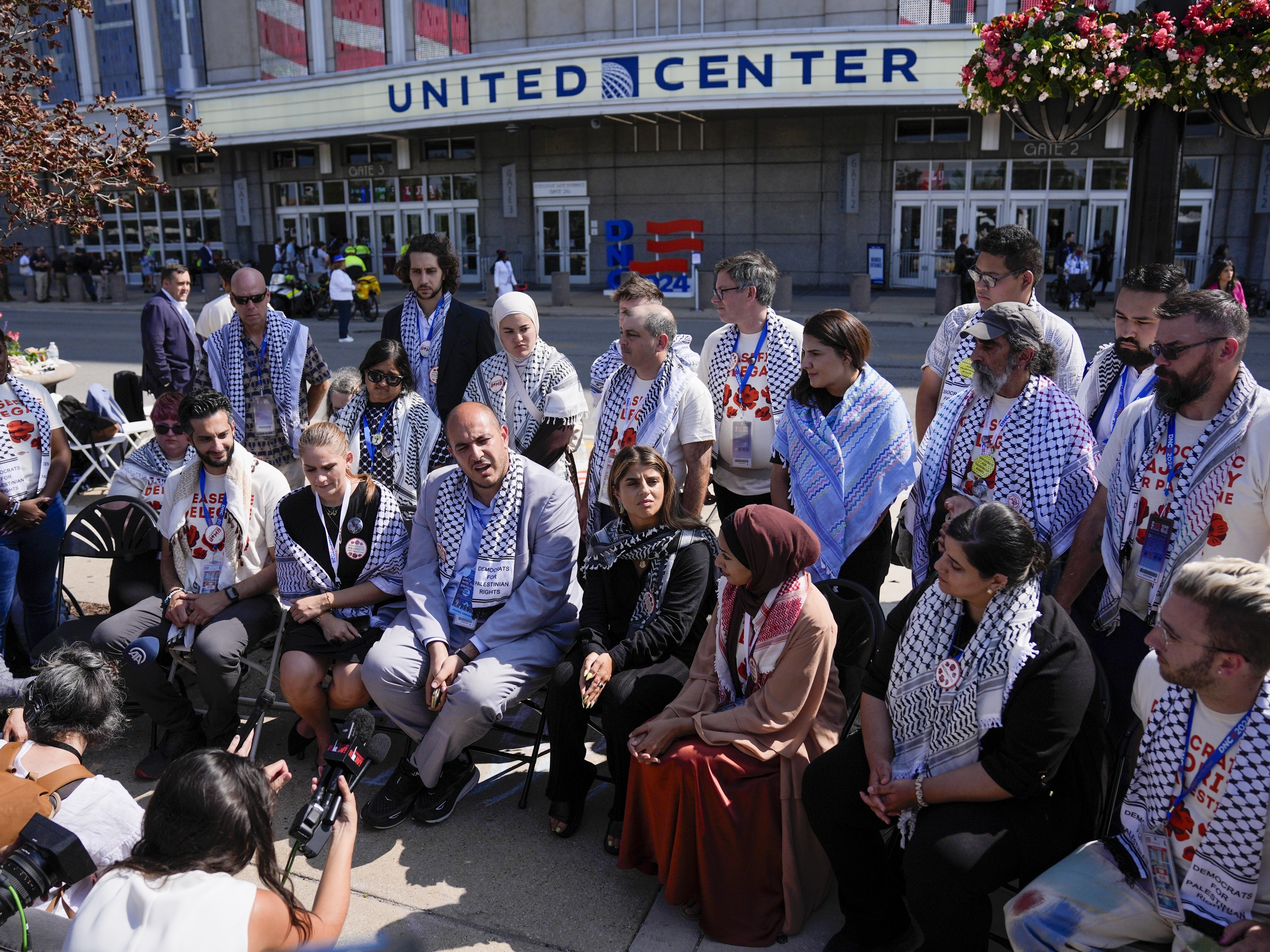 caption: Uncommitted delegates hold a press conference outside the United Center before the Democratic National Convention on Aug. 22 in Chicago. 