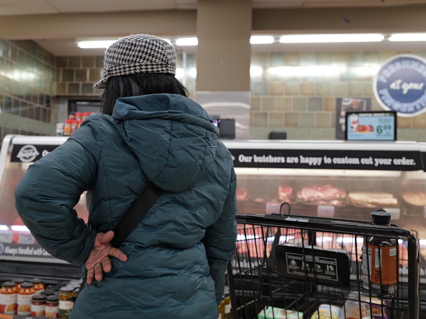 caption: A customer shops at a grocery store in Chicago on Feb. 13, 2024. Annual inflation has eased significantly since two years ago but it has remained stubbornly above 3% this year.
