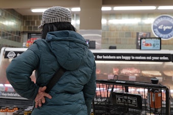 caption: A customer shops at a grocery store in Chicago on Feb. 13, 2024. Annual inflation has eased significantly since two years ago but it has remained stubbornly above 3% this year.