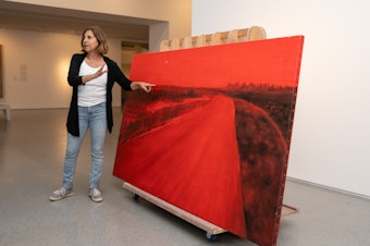 caption: Rescued from her studio in Kibbutz Be'eri near Israel's border with Gaza, artist Ziva Jelin's damaged painting <em>Curving Road </em>is currently on special display in the Israeli Art gallery of the Israel Museum in Jerusalem.