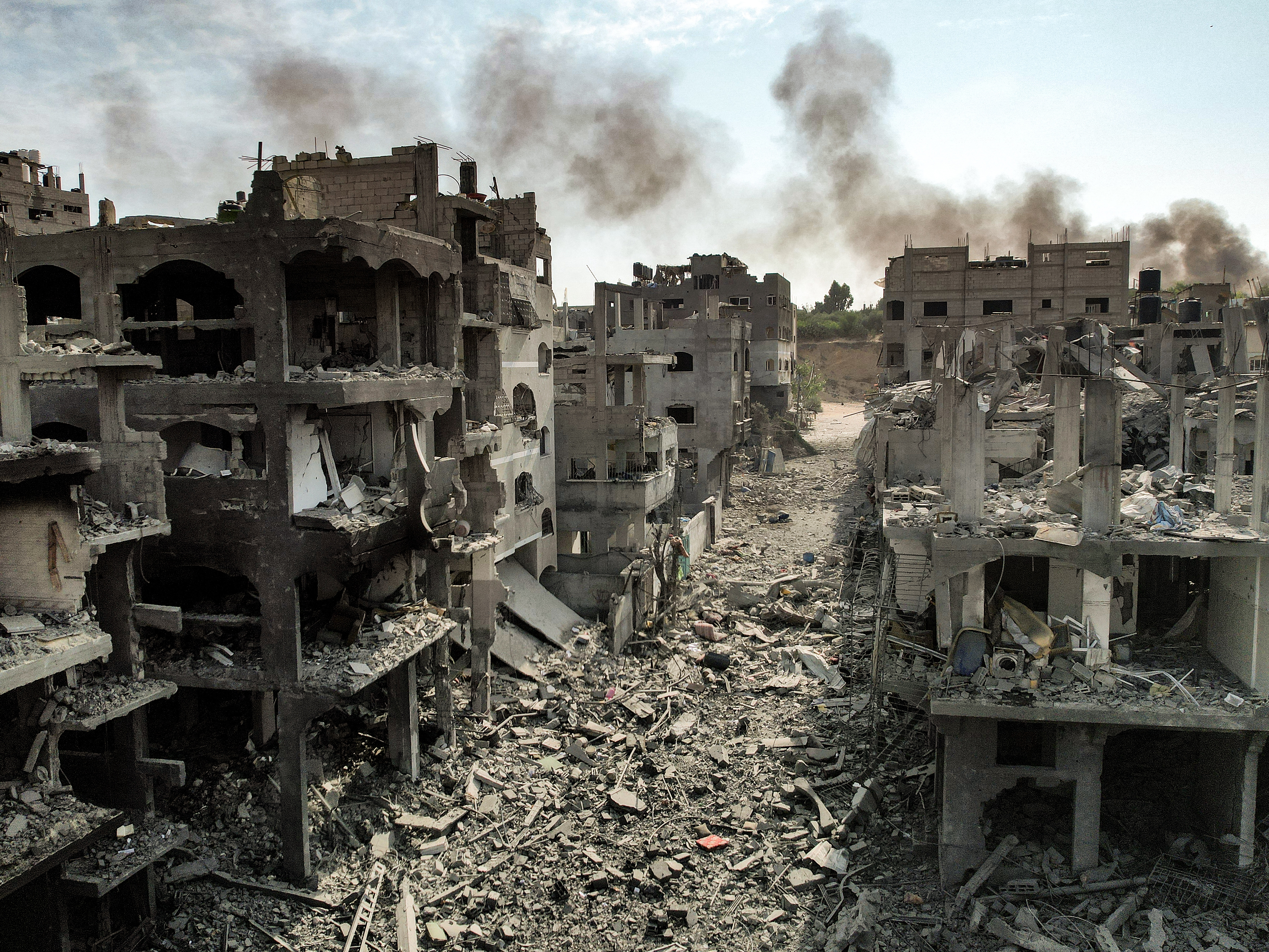 caption: Buildings destroyed by Israeli airstrikes in Gaza's Jabalia camp for Palestinian refugees on Oct. 11, 2023.