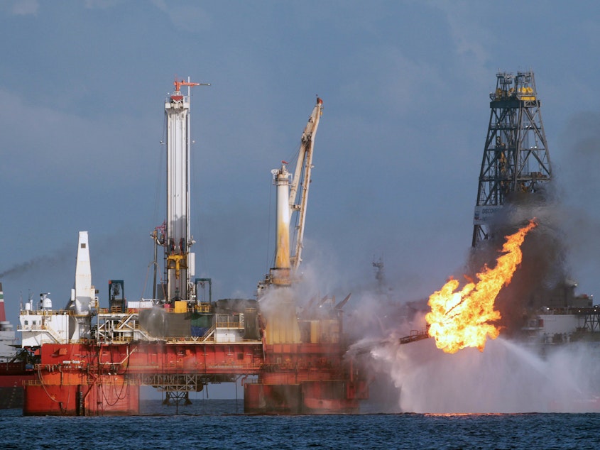 caption: The Deepwater Horizon oil rig is seen here in July 2010, shortly before the Macondo well was capped after spilling oil for 87 days. The Trump administration has proposed revisions to Obama-era rules that aimed to prevent similar disasters.