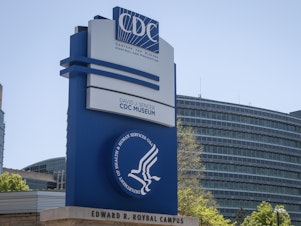 caption: A sign at the entrance to the Centers for Disease Control and Prevention is seen on April 19 in Atlanta.